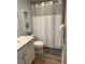 Bathroom features a shower/tub, vanity, and coastal-themed artwork for a relaxing atmosphere at 371 S Dunes Dr., Pawleys Island, SC 29585