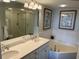 Full bathroom with double sinks, garden tub and a glass enclosed shower at 371 S Dunes Dr., Pawleys Island, SC 29585