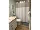 Bathroom features a shower/tub, vanity, and coastal-themed artwork for a relaxing atmosphere at 371 S Dunes Dr., Pawleys Island, SC 29585