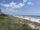 Expansive beachfront with ocean views, sunshades, and dunes showcasing a relaxing coastal lifestyle at 371 S Dunes Dr., Pawleys Island, SC 29585