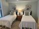 Comfortable guest bedroom boasts twin beds, coastal decor, and a light, airy ambiance at 371 S Dunes Dr., Pawleys Island, SC 29585