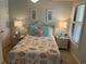 Charming bedroom features a queen bed, coastal-themed decor, and plenty of natural light at 371 S Dunes Dr., Pawleys Island, SC 29585