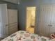 View of a quaint bedroom showing a dresser with an open doorway leading to the bathroom at 371 S Dunes Dr., Pawleys Island, SC 29585
