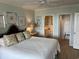 Comfortable bedroom featuring a large bed, soothing colors and ensuite bathroom access at 371 S Dunes Dr., Pawleys Island, SC 29585
