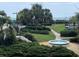 Beautiful grounds with lush landscaping, walking path, and a water feature at 371 S Dunes Dr., Pawleys Island, SC 29585