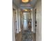 Inviting hallway with wood floors, neutral walls, detailed trim and attractive fish-themed rug at 371 S Dunes Dr., Pawleys Island, SC 29585