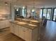 Bright, open kitchen and living area with granite countertops and stylish seating at the kitchen island at 371 S Dunes Dr., Pawleys Island, SC 29585