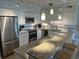 Modern kitchen features stainless steel appliances, granite counters, and bright pendant lighting at 371 S Dunes Dr., Pawleys Island, SC 29585