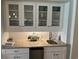 Kitchen wet bar features granite counters, a fish accent piece, and glass front upper cabinets at 371 S Dunes Dr., Pawleys Island, SC 29585