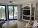 Comfortable living room features a large glass door leading to an outdoor balcony and built-in shelving at 371 S Dunes Dr., Pawleys Island, SC 29585