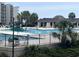 Community pool featuring a gazebo, lounge chairs, and umbrellas amidst lush landscaping at 371 S Dunes Dr., Pawleys Island, SC 29585