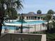 View of the community pool, featuring lounge chairs and tropical landscaping at 371 S Dunes Dr., Pawleys Island, SC 29585