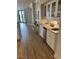 Stylish wet bar with granite counters, white cabinets, under cabinet lighting and a beverage refrigerator at 371 S Dunes Dr., Pawleys Island, SC 29585