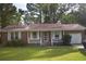Charming brick home with white trim, a cozy front porch, and a well-manicured green lawn at 3909 Mallard Circle, Myrtle Beach, SC 29579