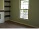 Bright living room with new light-colored walls, hardwood floors, a large window and wooden shelving at 3909 Mallard Circle, Myrtle Beach, SC 29579