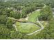 Aerial view of a meticulously maintained golf course with lush greenery and a tranquil water hazard at 405 Pipers Ln. # 405, Myrtle Beach, SC 29575