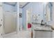 Light blue bathroom featuring a white shower, toilet, and granite vanity with a white vessel sink at 405 Pipers Ln. # 405, Myrtle Beach, SC 29575