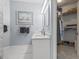 Bright bathroom featuring double sinks, vanity with cabinet storage and a door to a large closet at 405 Pipers Ln. # 405, Myrtle Beach, SC 29575