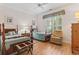 Well-lit bedroom with two beds, a large window, and cozy seating area at 405 Pipers Ln. # 405, Myrtle Beach, SC 29575