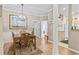 Dining room view with hardwood floors, trim work and a glimpse into the kitchen at 405 Pipers Ln. # 405, Myrtle Beach, SC 29575