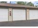 The garages with white doors and a fire extinguisher on the left side at 405 Pipers Ln. # 405, Myrtle Beach, SC 29575