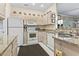 Kitchen with neutral cabinets, granite counters and white appliances at 405 Pipers Ln. # 405, Myrtle Beach, SC 29575