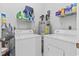 Small laundry room with stacked washer and dryer and storage shelves at 405 Pipers Ln. # 405, Myrtle Beach, SC 29575