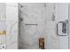 Modern shower featuring marble look tiles and a shower bench with safety bar at 405 Pipers Ln. # 405, Myrtle Beach, SC 29575