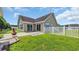 Fenced in backyard with a brick firepit and lush green lawn at 405 Vintage Circle, Myrtle Beach, SC 29579