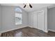 A cozy bedroom with wood-look floors, ceiling fan and natural light from the window at 405 Vintage Circle, Myrtle Beach, SC 29579