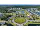 Expansive aerial view of a community with lush landscaping, a sparkling lake, and various recreational amenities at 4115 Bayhill St., Myrtle Beach, SC 29579