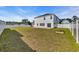 Large backyard featuring a white fence, grass lawn, and a house at 4115 Bayhill St., Myrtle Beach, SC 29579