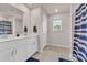 Bathroom featuring double sinks, tile flooring, and a decorative shower curtain at 4115 Bayhill St., Myrtle Beach, SC 29579