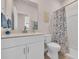 Clean bathroom features vanity with sink, a toilet, and a shower with blue-patterned curtain at 4115 Bayhill St., Myrtle Beach, SC 29579
