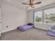 Bedroom featuring carpet, a ceiling fan, and large windows at 4115 Bayhill St., Myrtle Beach, SC 29579