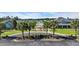 Community entrance featuring lush landscaping, palm trees, and a charming gazebo, creating a welcoming atmosphere at 4115 Bayhill St., Myrtle Beach, SC 29579