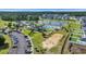 Aerial view of the community pool area with a pool, clubhouse, parking, and green spaces in the community at 4115 Bayhill St., Myrtle Beach, SC 29579
