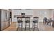 Beautiful kitchen with stainless steel refrigerator, white cabinets, mosaic backsplash, and kitchen island with chairs at 4115 Bayhill St., Myrtle Beach, SC 29579