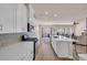 Bright and open kitchen featuring white cabinets, stainless steel appliances, and a kitchen island with seating at 4115 Bayhill St., Myrtle Beach, SC 29579