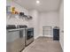 Bright laundry room features stainless steel washer and dryer set with built-in shelving at 4115 Bayhill St., Myrtle Beach, SC 29579