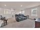 Upstairs living room with black leather reclining couch, carpet, and multiple windows at 4115 Bayhill St., Myrtle Beach, SC 29579