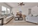 Cozy living room with comfortable seating, a ceiling fan and views of the outside through two large windows at 4115 Bayhill St., Myrtle Beach, SC 29579
