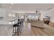 Open-concept living space featuring a modern kitchen island, dining area, and comfortable seating with lots of natural light at 4115 Bayhill St., Myrtle Beach, SC 29579