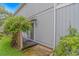 View of the back of the home, showing the small patio with greenery and a sliding glass door at 4309 Beverly Ct., North Myrtle Beach, SC 29582