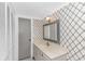 Stylish bathroom featuring patterned wallpaper, a bright vanity, and modern fixtures at 4309 Beverly Ct., North Myrtle Beach, SC 29582