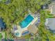 Aerial shot of a luxurious pool surrounded by lounge chairs and lush trees at 4309 Beverly Ct., North Myrtle Beach, SC 29582