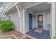 Welcoming entrance featuring a storm door, blue accents, and well-kept landscaping at 4309 Beverly Ct., North Myrtle Beach, SC 29582