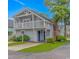 Charming two-story beach home with a balcony, covered entrance, and well-manicured landscaping at 4309 Beverly Ct., North Myrtle Beach, SC 29582