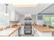 Well-lit kitchen with wood countertops, white cabinets, and modern appliances at 4309 Beverly Ct., North Myrtle Beach, SC 29582