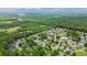 The aerial perspective highlights the home's location within a leafy neighborhood near a coastal landscape at 434 Deer Path, Calabash, NC 28467